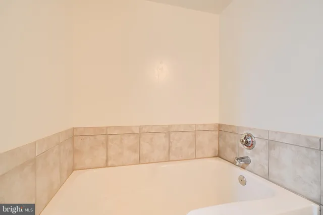 a bathroom with a granite countertop sink toilet and bathtub