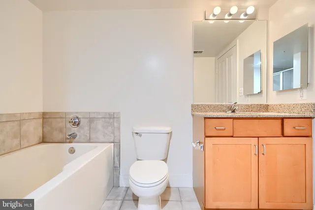 an empty room with a glass door and shower