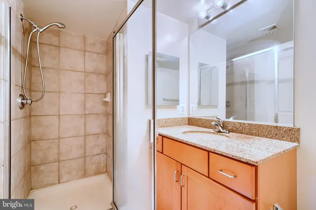 a view of walk in closet with white walls