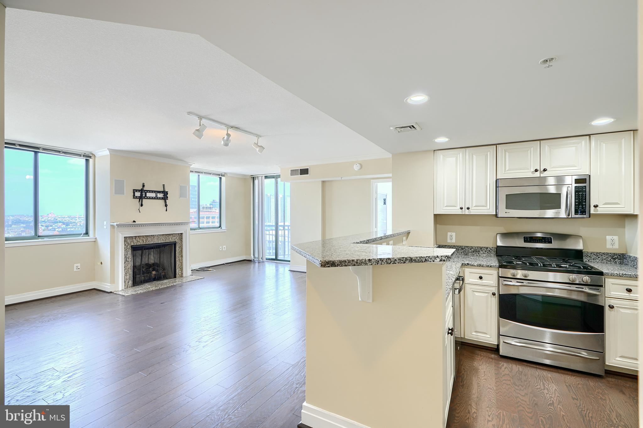 414 Water Street, Unit 1513 Baltimore, MD 21202 - Photo 7 of 43 a kitchen with stainless steel appliances a stove top oven and refrigerator