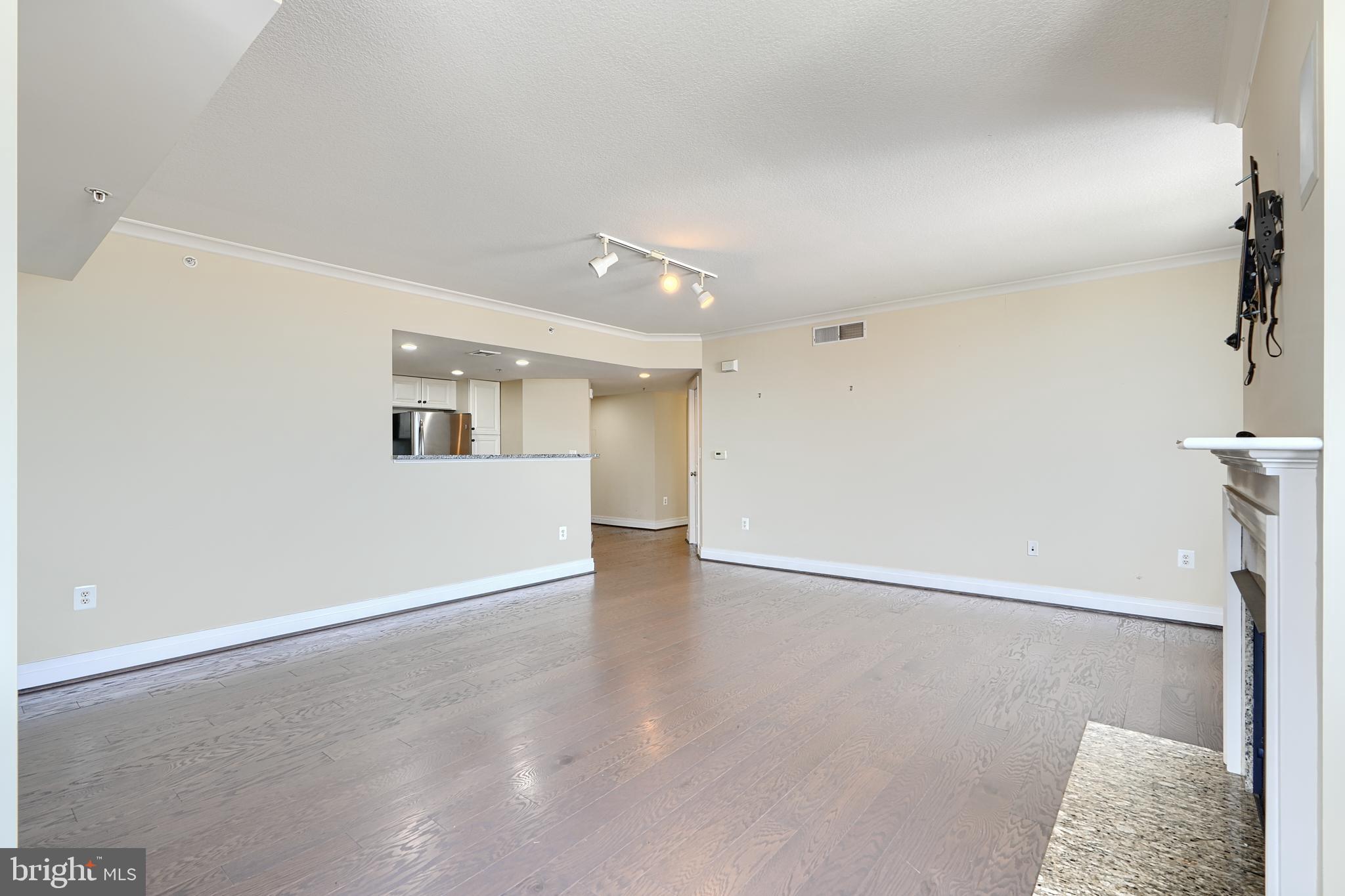414 Water Street, Unit 1513 Baltimore, MD 21202 - Photo 9 of 43 wooden floor in an empty room