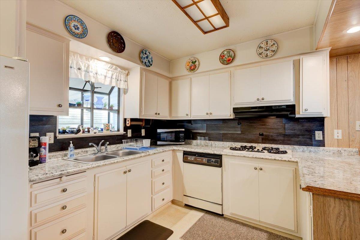 1272 Villa Avenue, Unit SPC56 Clovis, CA 93612 - Photo 12 of 35 a kitchen with cabinets appliances a sink and a window