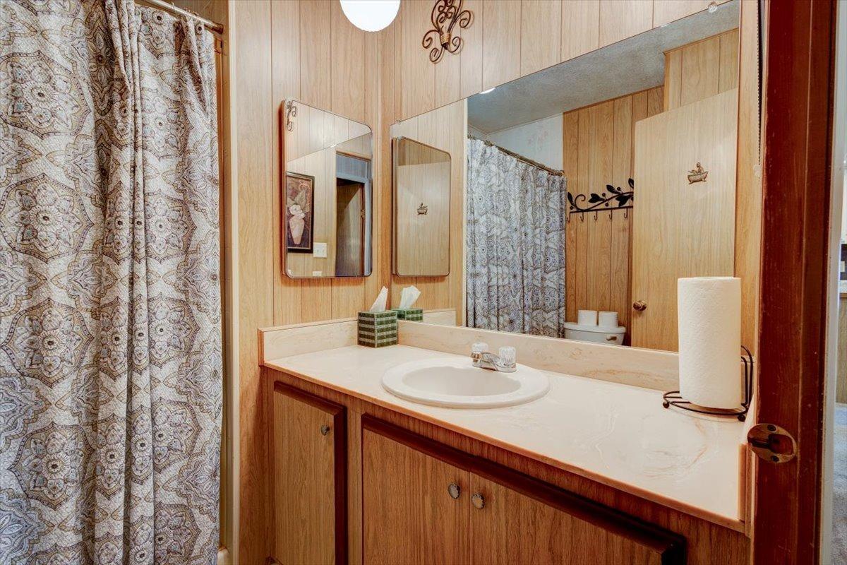 1272 Villa Avenue, Unit SPC56 Clovis, CA 93612 - Photo 14 of 35 a bathroom with a sink and a mirror