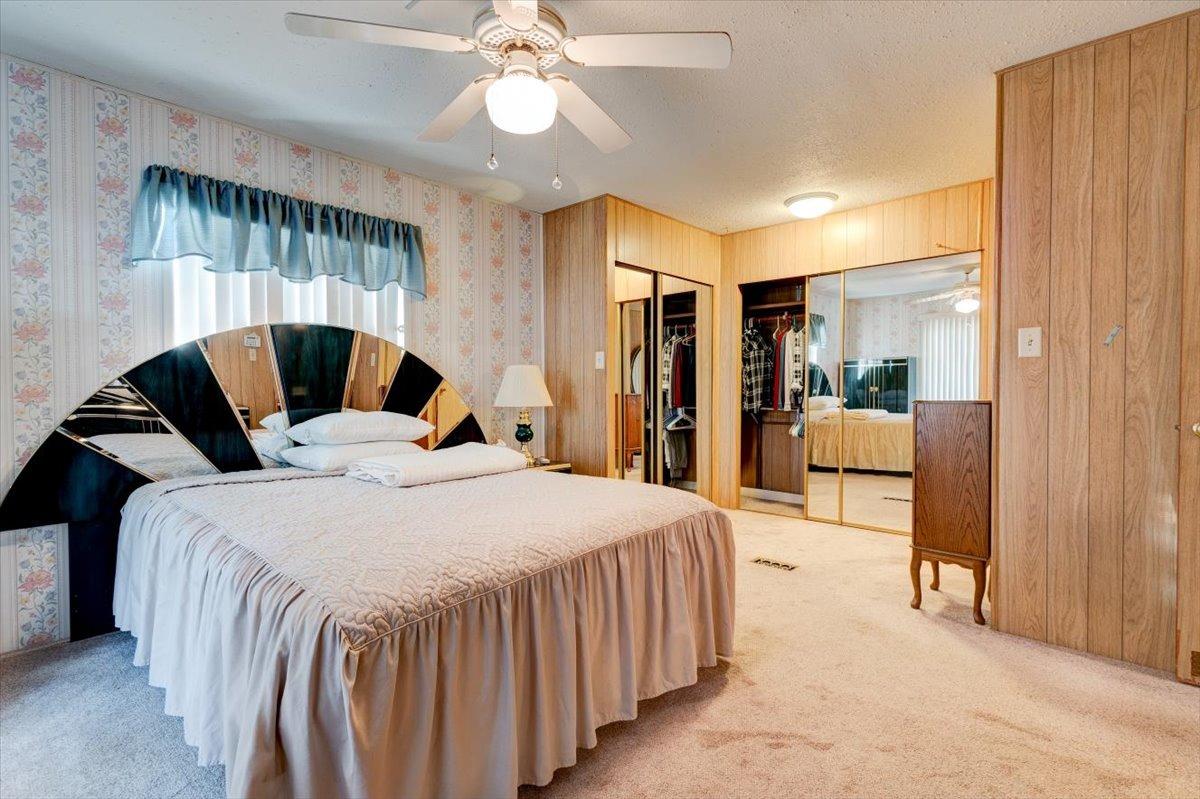 1272 Villa Avenue, Unit SPC56 Clovis, CA 93612 - Photo 16 of 35 a bedroom with a bed and a chandelier