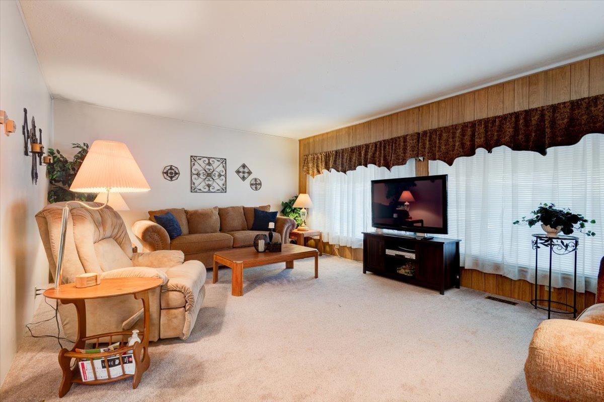 1272 Villa Avenue, Unit SPC56 Clovis, CA 93612 - Photo 6 of 35 a living room with furniture a flat screen tv and paintings on the wall