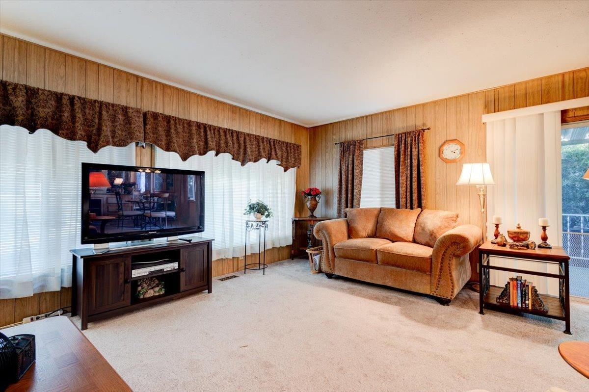 1272 Villa Avenue, Unit SPC56 Clovis, CA 93612 - Photo 7 of 35 a living room with furniture a flat screen tv and a wall painting