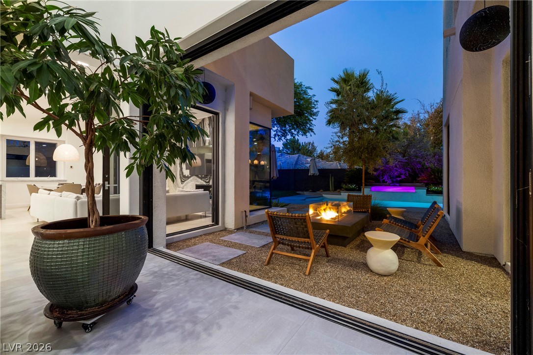 2000 Grouse Street Las Vegas, NV 89134 - Photo 63 of 89 An inviting outdoor oasis awaits with a captivating fire pit and pool under the evening sky.