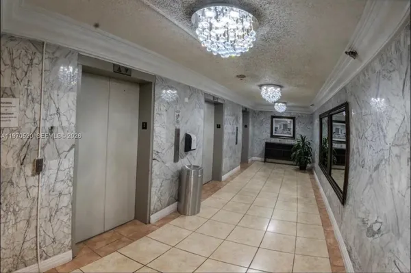 a spacious bedroom with a bed and a view of kitchen