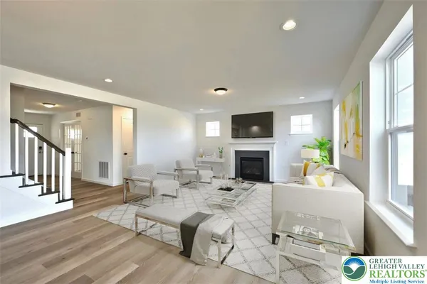 a living room with fireplace furniture and a flat screen tv