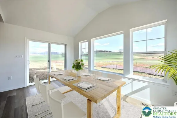 a living room with furniture and large windows