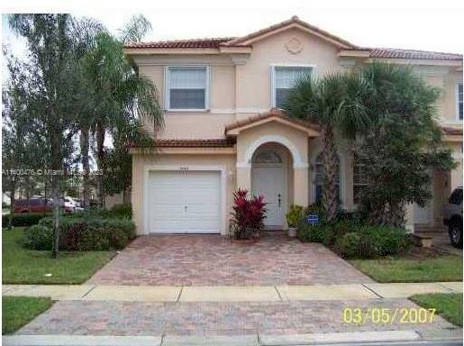8436 Southwest 29th Street, Unit 101 Miramar, FL 33025 - Photo 1 of 21 a front view of a house with garden