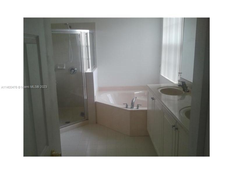 8436 Southwest 29th Street, Unit 101 Miramar, FL 33025 - Photo 11 of 21 a bathroom with a bathtub and shower