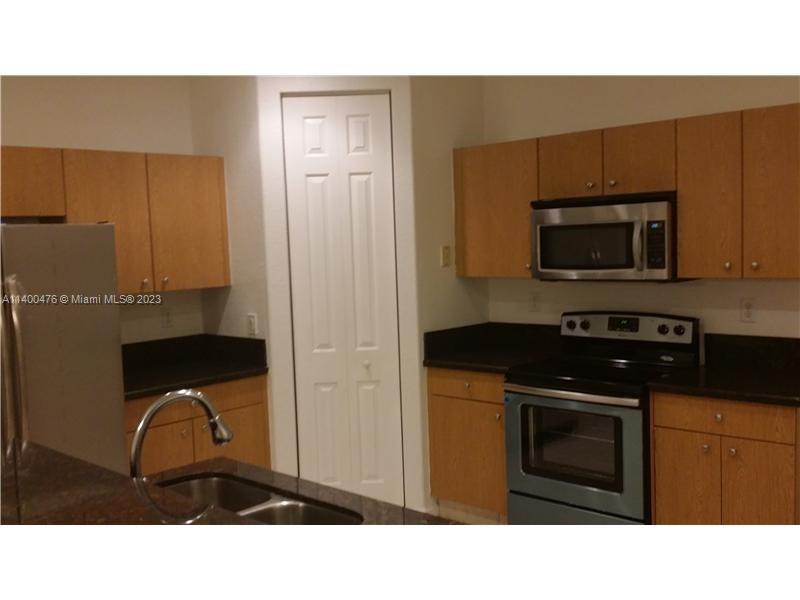 8436 Southwest 29th Street, Unit 101 Miramar, FL 33025 - Photo 4 of 21 a kitchen with a sink cabinets and stainless steel appliances