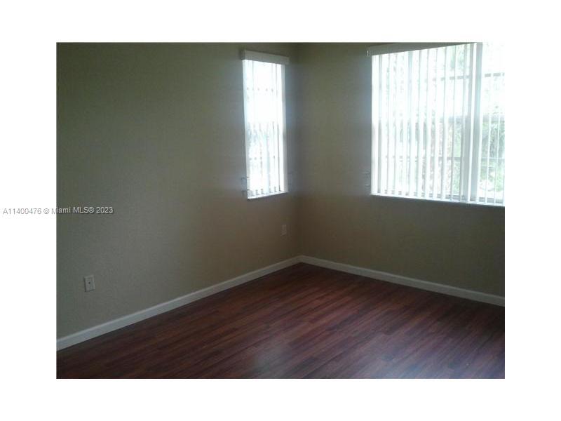 8436 Southwest 29th Street, Unit 101 Miramar, FL 33025 - Photo 10 of 21 a room with a window and wooden floor