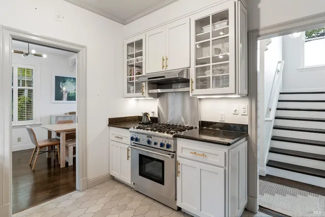 a kitchen with granite countertop a stove and a sink