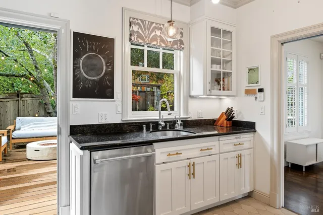 a kitchen with granite countertop a sink and a window