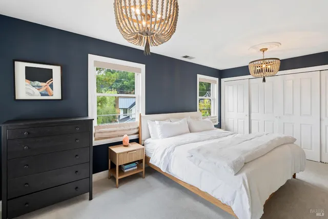 a bedroom with a bed and a chandelier