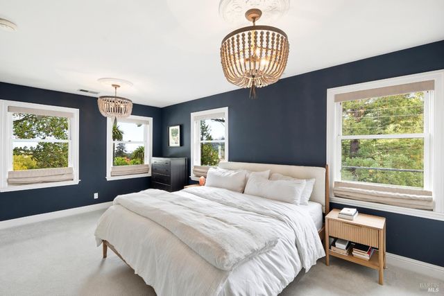 a bedroom with a large bed and a window