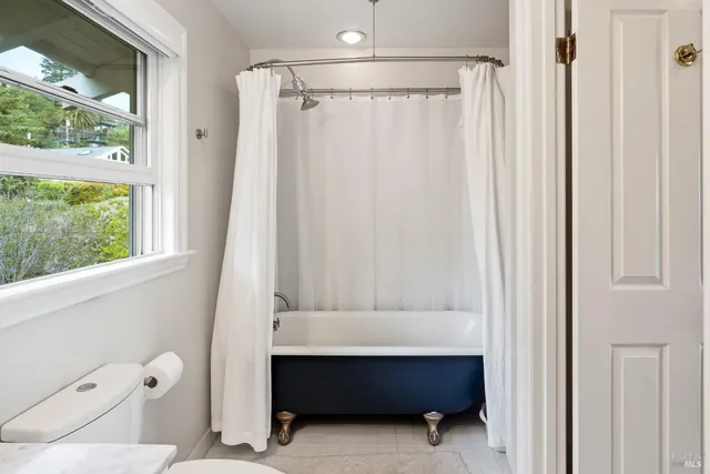 a bathroom with a toilet and a shower