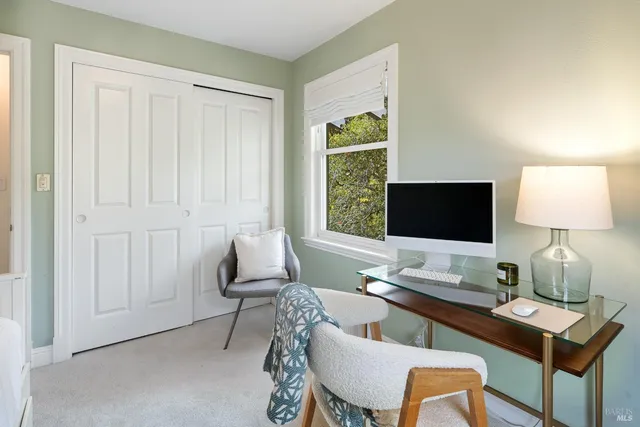 a bedroom with a bed and windows