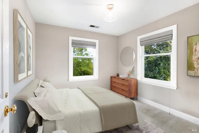 a view of a bedroom with a large window and bed