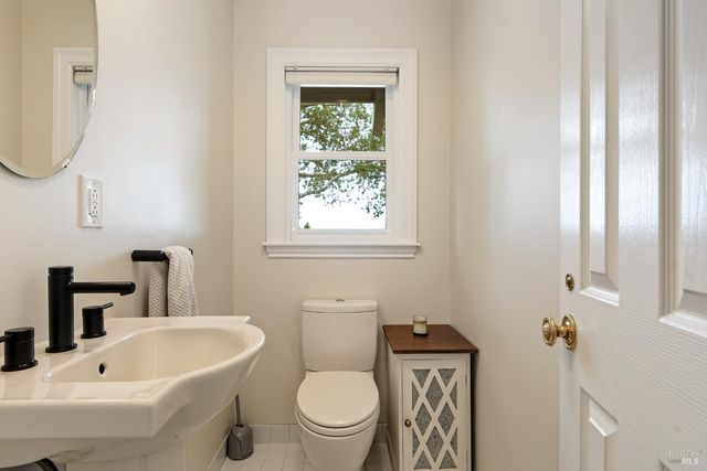 a bathroom with a toilet a sink and a mirror