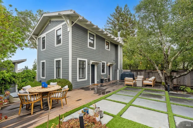 a front view of a house with a yard table and chairs