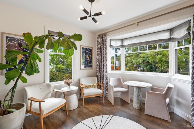 a living room with patio furniture and a potted plant