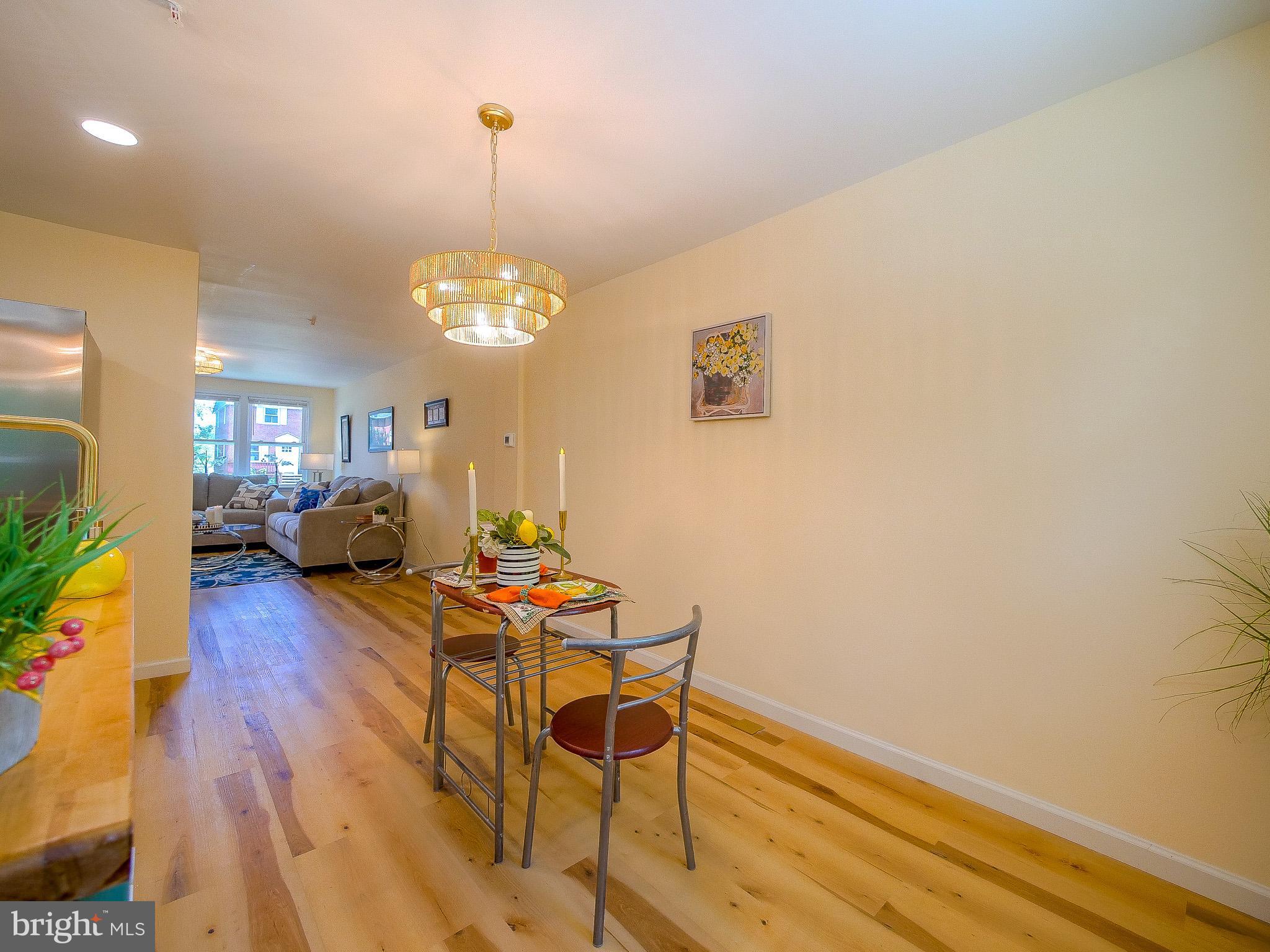 179 Madison Drive Newark, DE 19711 - Photo 11 of 43 a living room with furniture a dining table and a chandelier