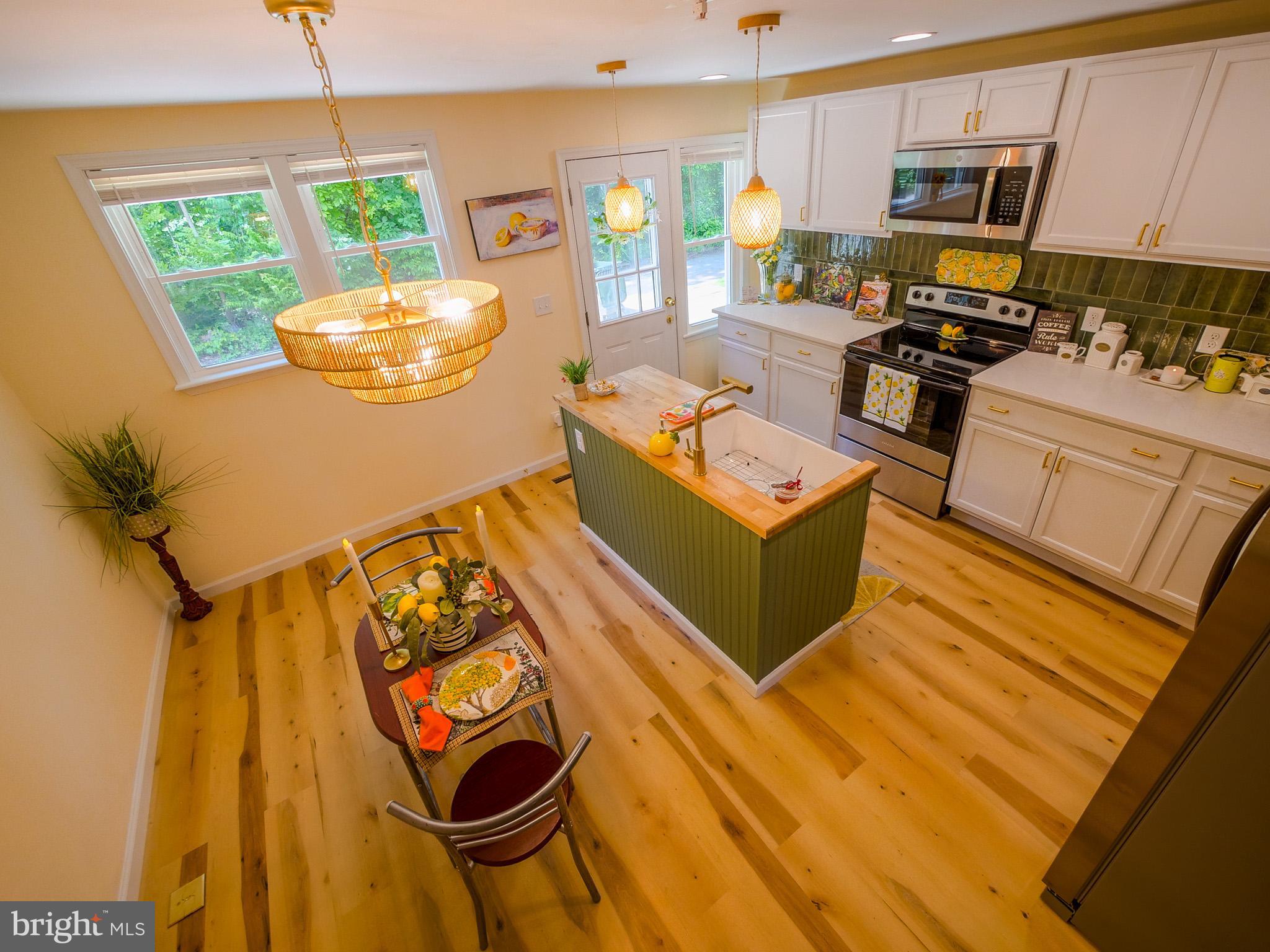 179 Madison Drive Newark, DE 19711 - Photo 13 of 43 a kitchen with stainless steel appliances wooden floor and a sink