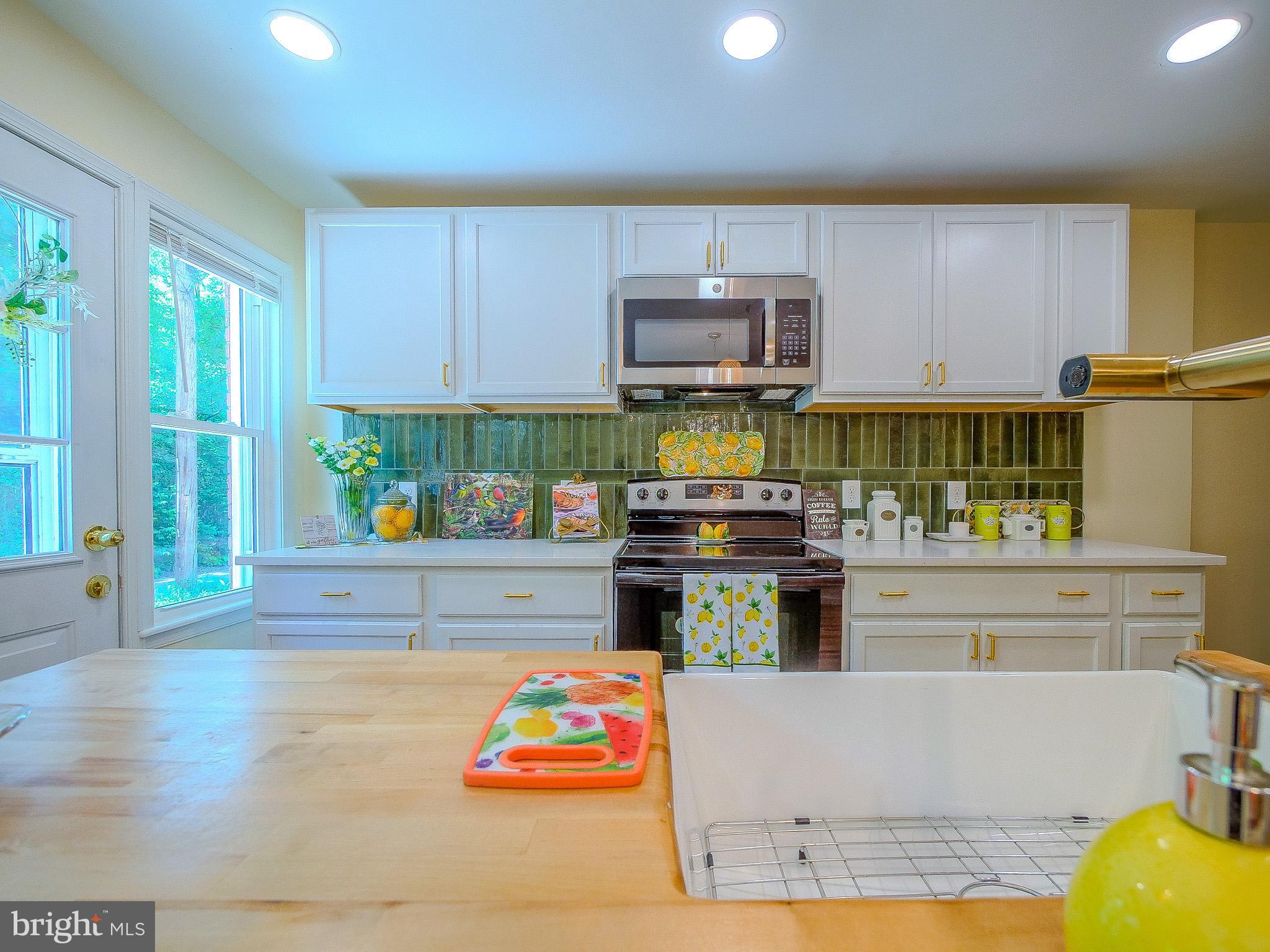 179 Madison Drive Newark, DE 19711 - Photo 20 of 43 a kitchen with stainless steel appliances granite countertop a stove and a refrigerator