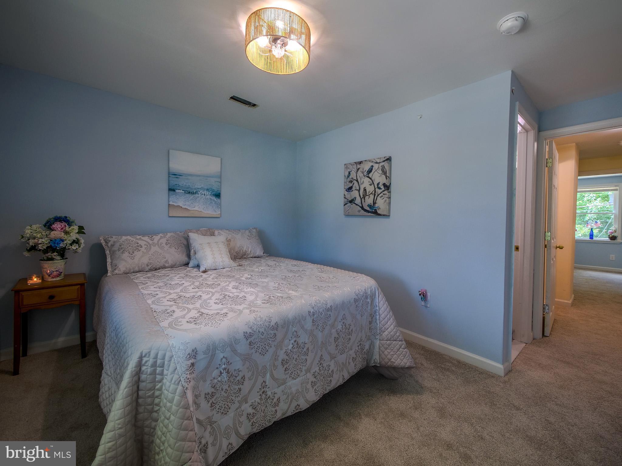 179 Madison Drive Newark, DE 19711 - Photo 22 of 43 a bedroom with a bed and a chandelier