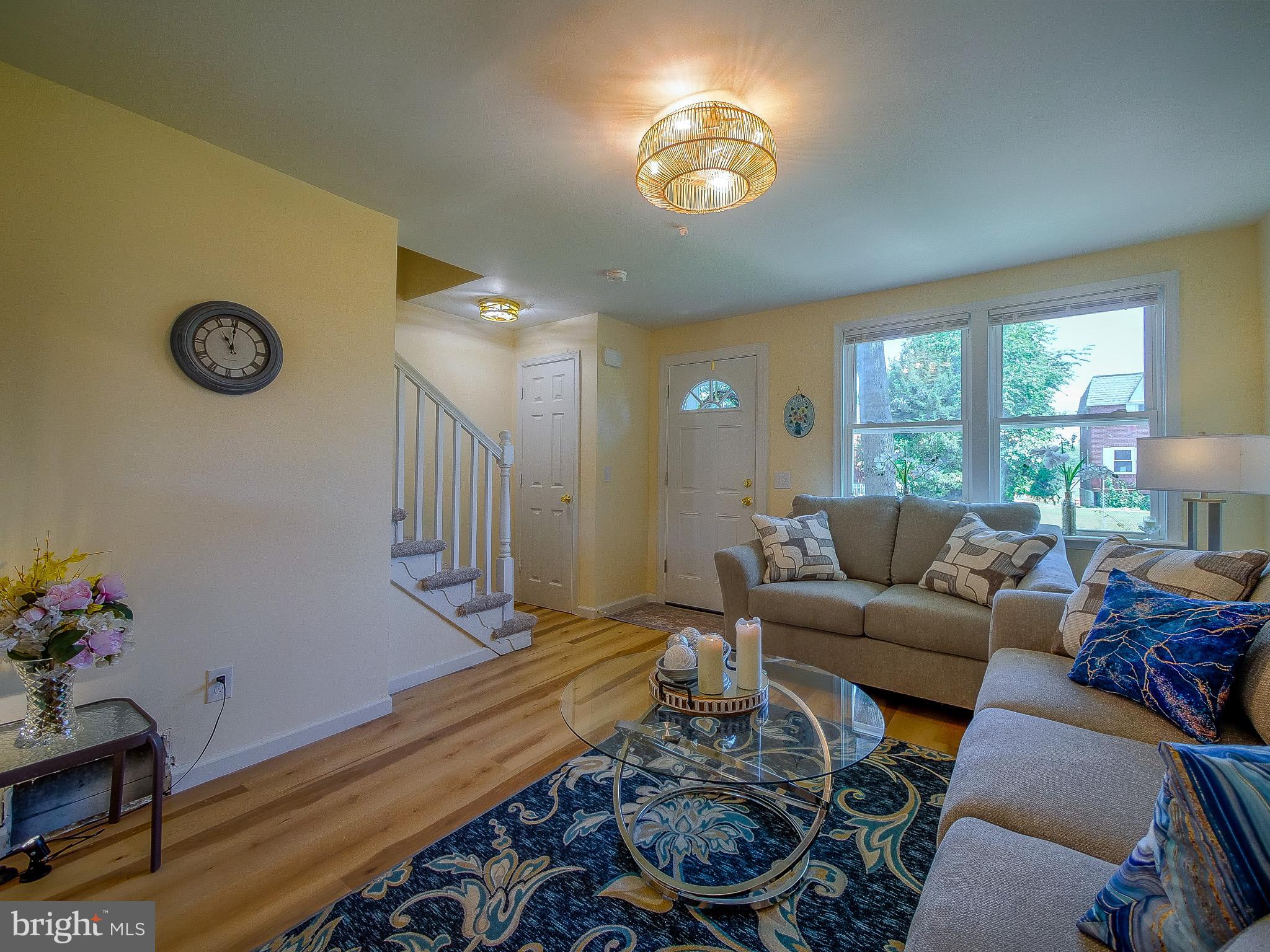 179 Madison Drive Newark, DE 19711 - Photo 8 of 43 a living room with furniture a chandelier and a window