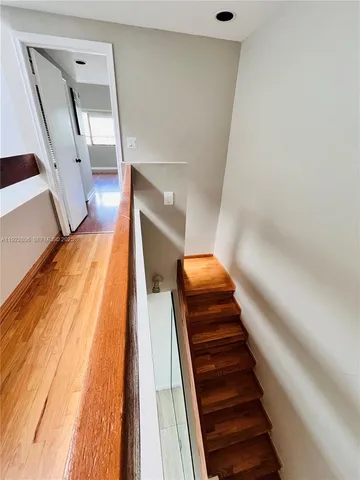 a view of hallway with wooden floor