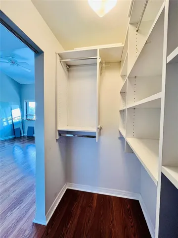 a view of walk in closet with empty racks