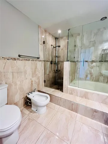 a bathroom with a tub a double vanity sink and mirror