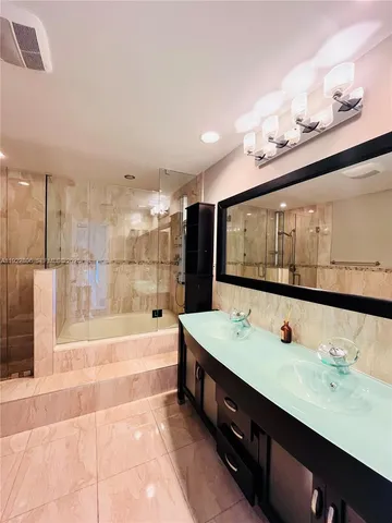 a bathroom with a bathtub and a shower