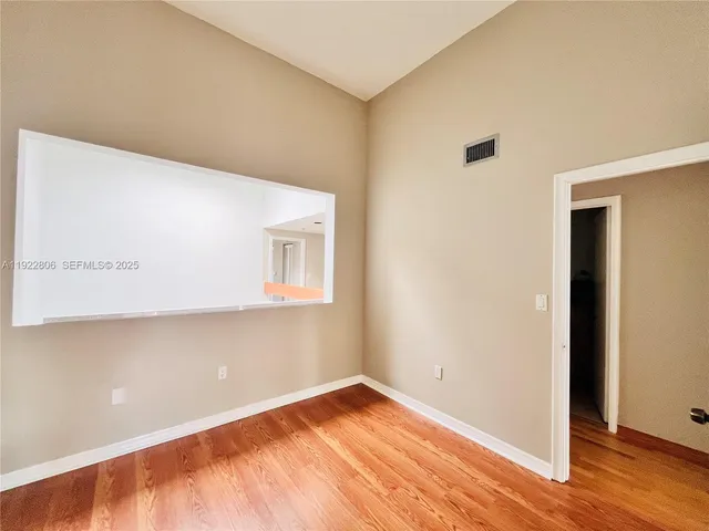 a view of a yard with a chair and potted plants