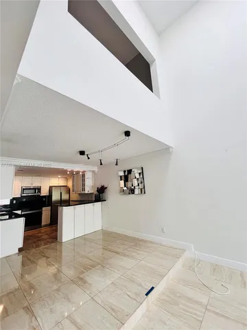 a view of a living room with kitchen