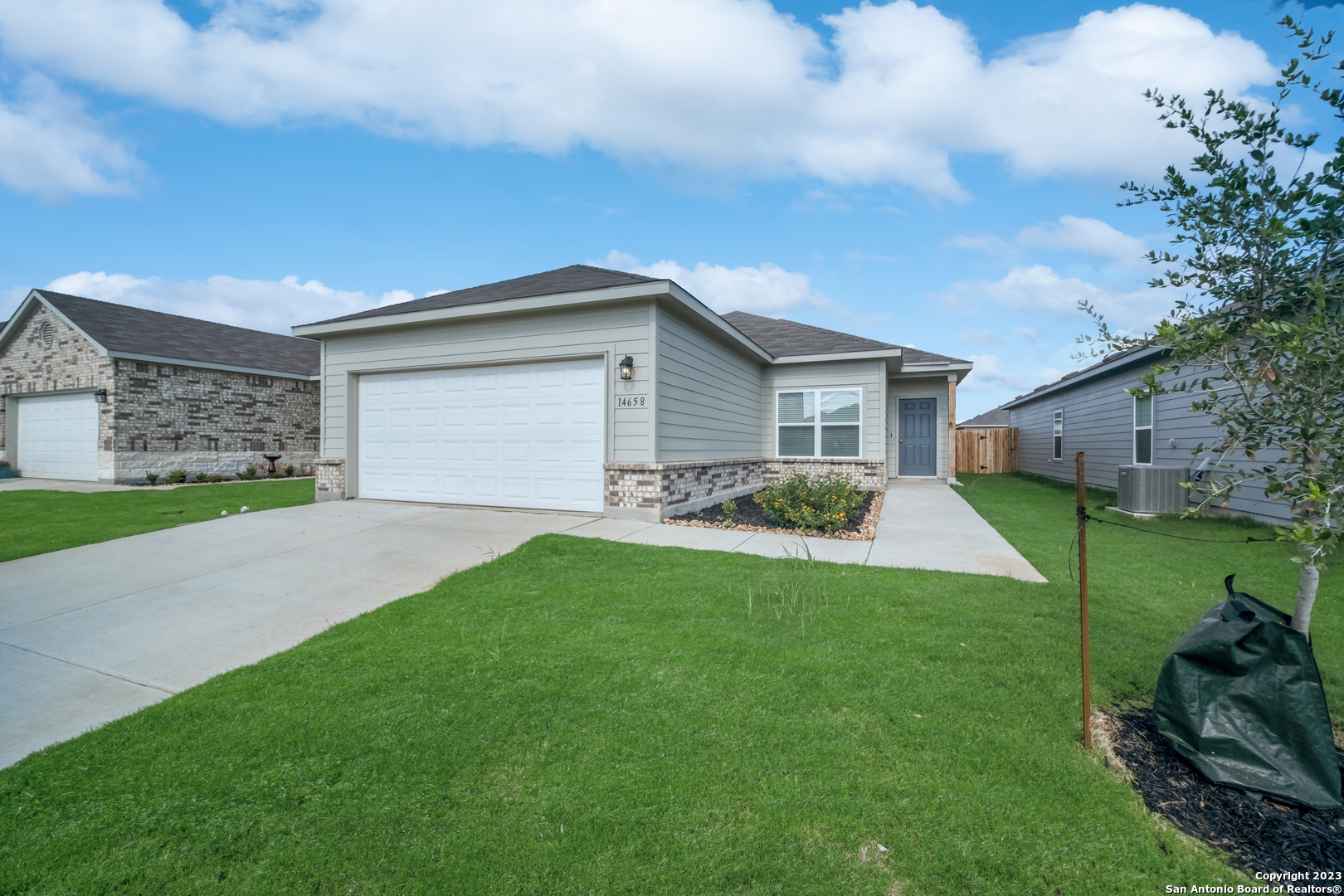 a front view of house with yard and green space