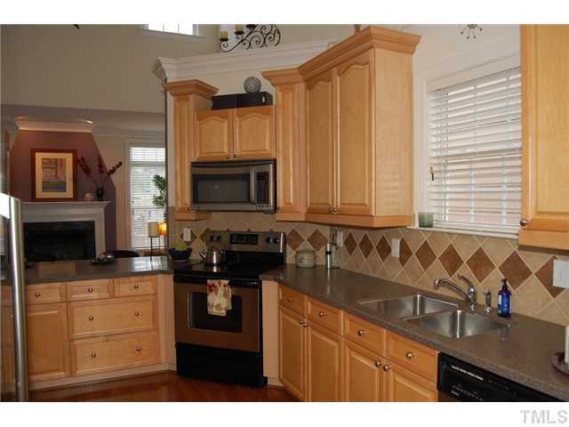 1148 Harp Street Raleigh, NC 27604 - Photo 3 of 23 Central to this home, this kitchen plays an integral role to entertaining and gatherings. From the breakfast bar along the family room peninsula to the sunny breakfast room, there is plenty of room for enjoying hours of leisure.