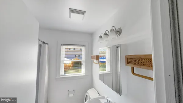 a bathroom with a window and a shower