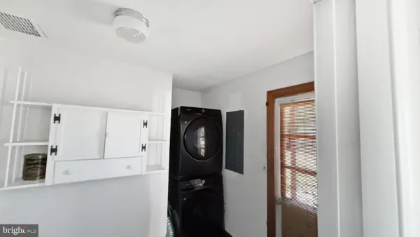 a bathroom with a walk in closet and mirror in closet