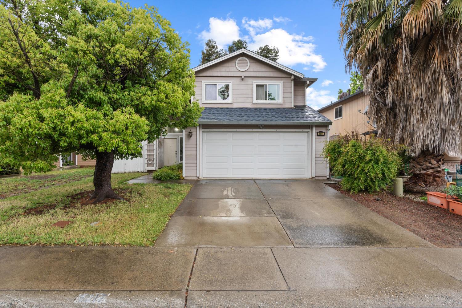 a front view of a house with a yard and garage
