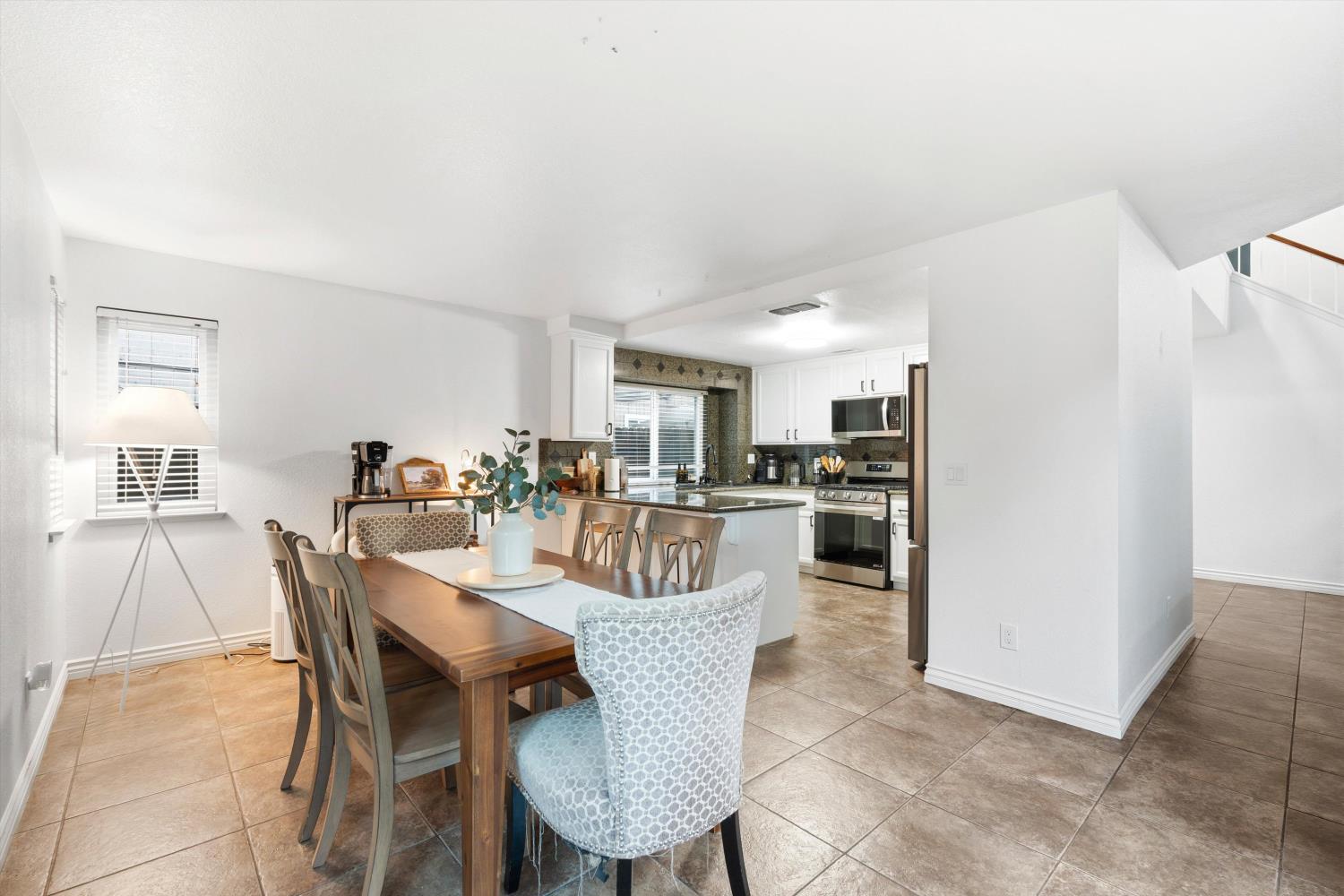 8117 Prior Way Antelope, CA 95843 - Photo 12 of 27 a view of a dining room with furniture and wooden floor