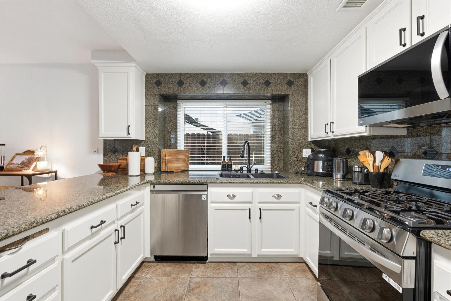 8117 Prior Way Antelope, CA 95843 - Photo 15 of 27 a kitchen with white cabinets and appliances