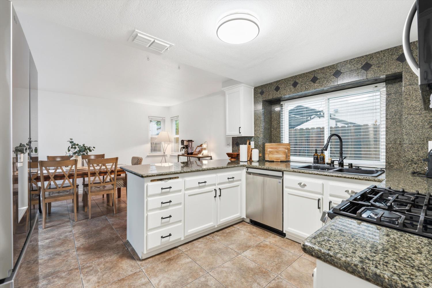8117 Prior Way Antelope, CA 95843 - Photo 16 of 27 a kitchen with a stove a sink and a refrigerator