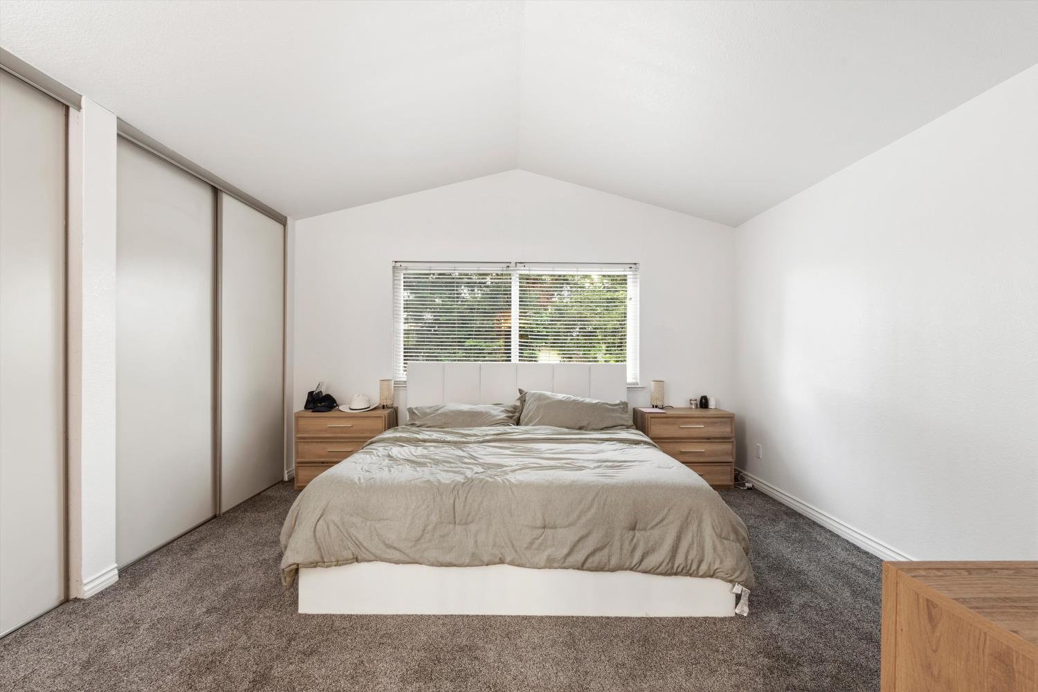 8117 Prior Way Antelope, CA 95843 - Photo 22 of 27 a large bed sitting in a bedroom next to a window