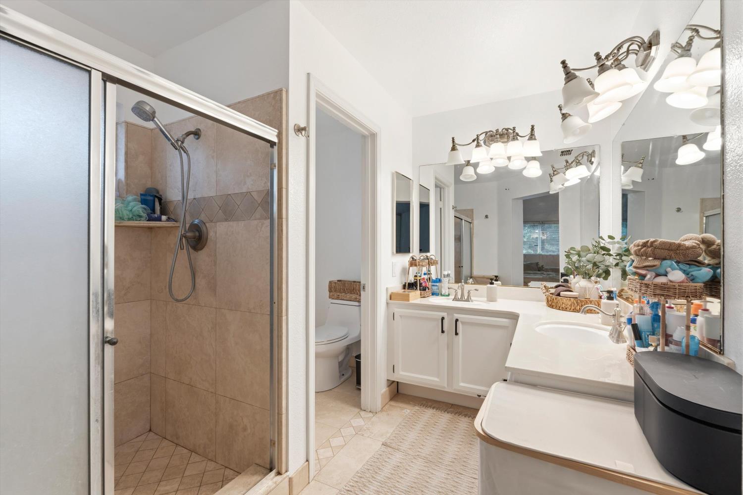 8117 Prior Way Antelope, CA 95843 - Photo 23 of 27 a bathroom with a tub sink vanity and mirror