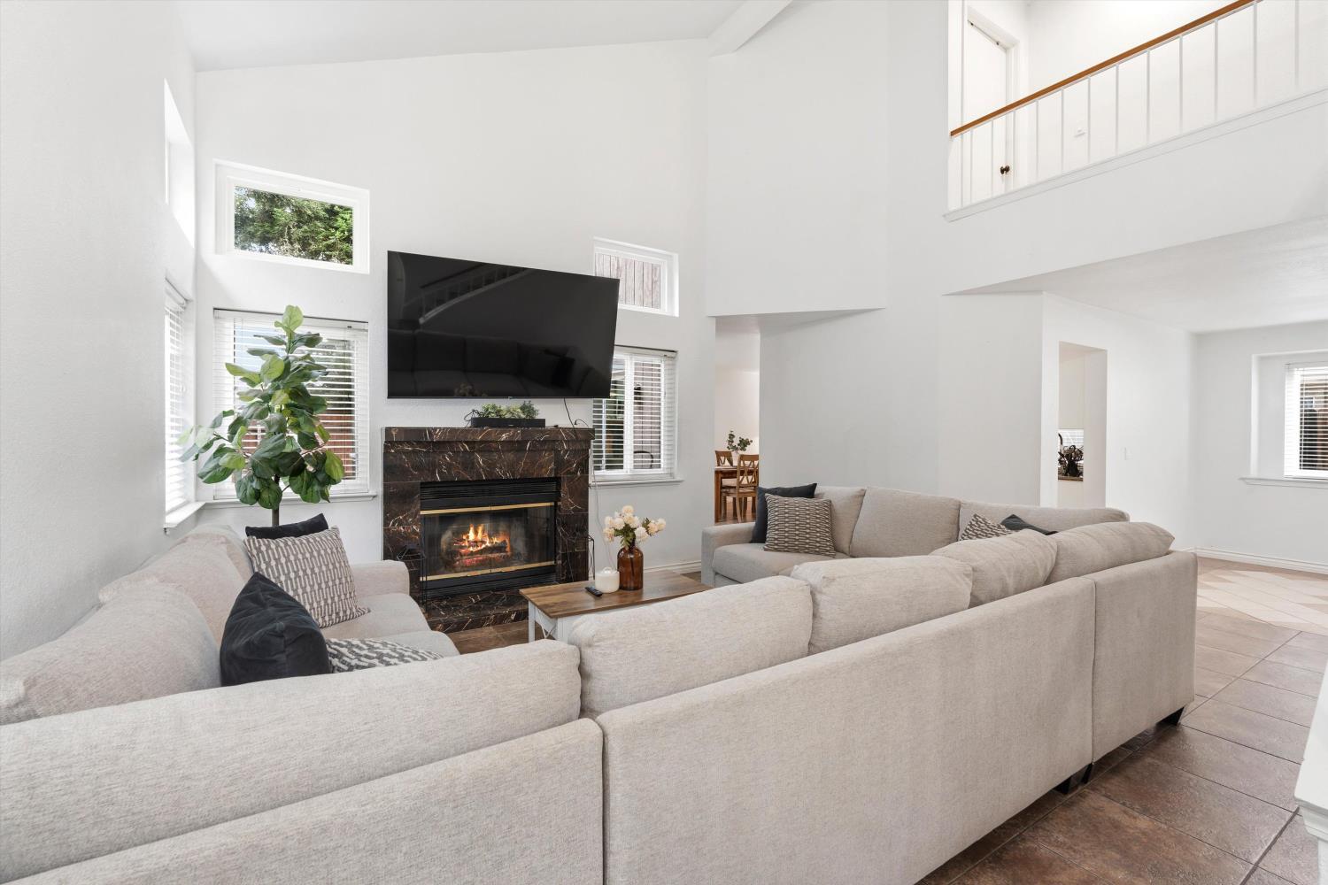 8117 Prior Way Antelope, CA 95843 - Photo 5 of 27 a living room with furniture a flat screen tv and a fireplace